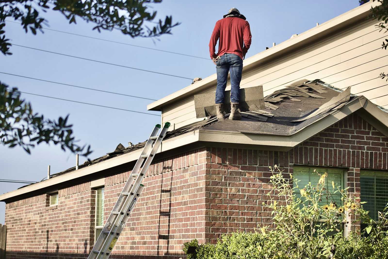 Roof professional working beside an extension ladder